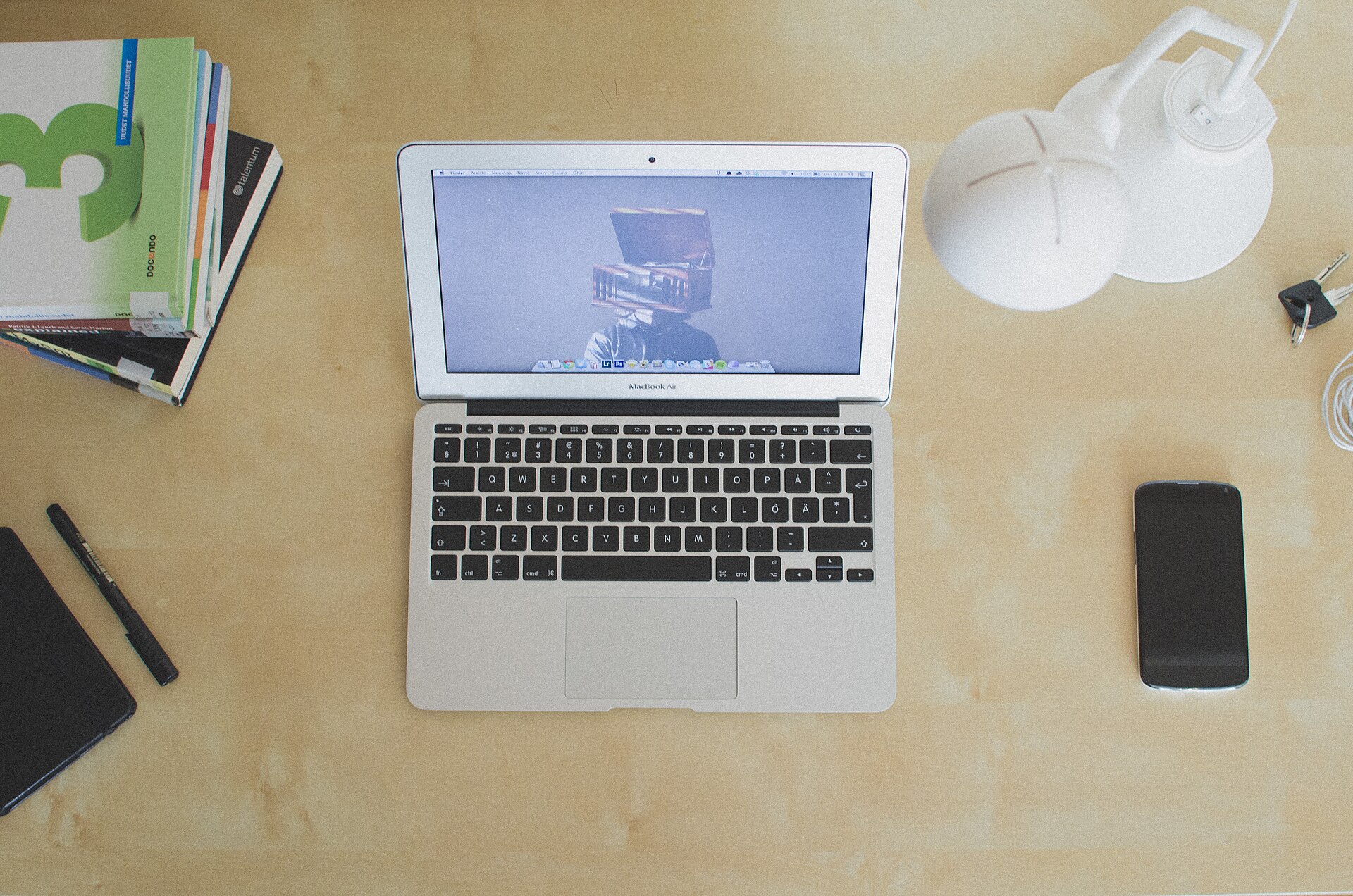 A Chromebook and a budget Windows laptop open side by side on a kitchen table next to a coffee mug on a Sunday morning